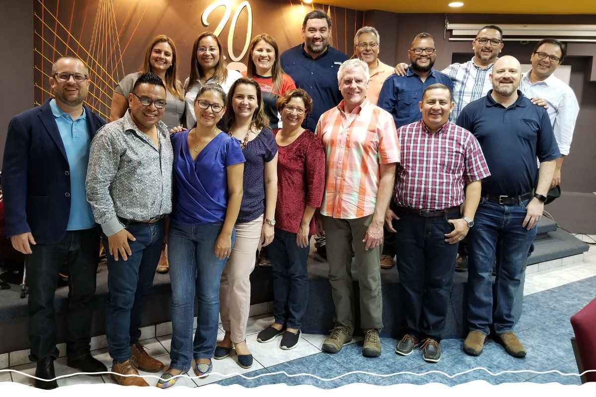 John Hanson (right front in dark shirt) volunteers with a team of business affiliates and local leaders in El Salvador.