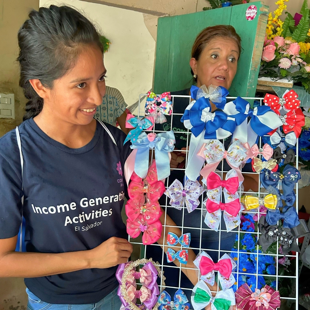 a smiling woman presents a display of bows